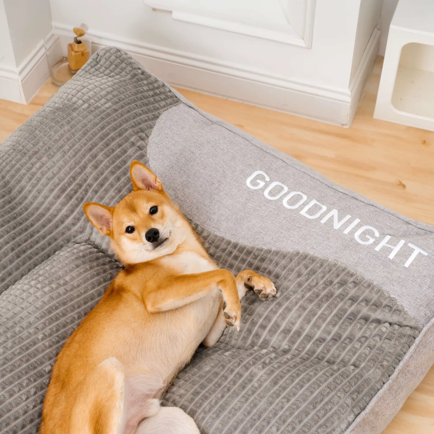 "Luxurious calming washable dog cushion in soft faux fur, available in sizes for all dogs, promotes stress-free relaxation."