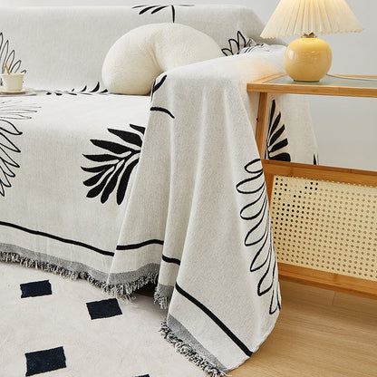 "Botanical sofa throw cover in stretchable protective fabric with elegant floral design fits snugly for modern home decor."
