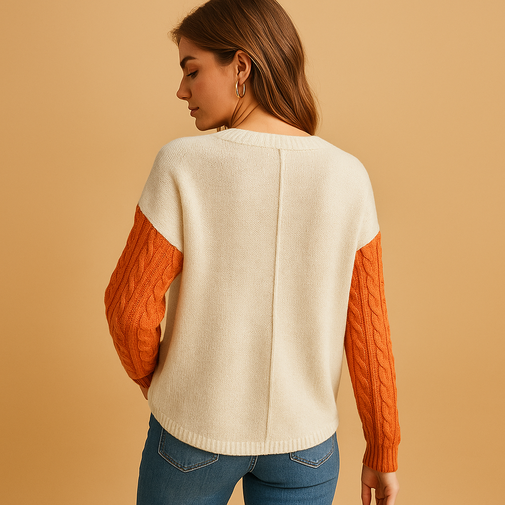 Women’s cable knit sweater with drop shoulders and a pocket detail, perfect for casual layering and everyday comfort.