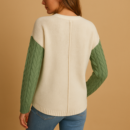 Women’s cable knit sweater with drop shoulders and a pocket detail, perfect for casual layering and everyday comfort.