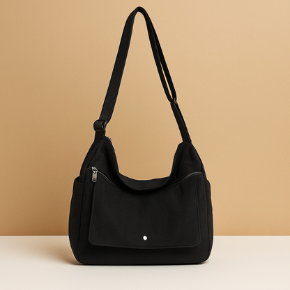 Canvas shoulder bag for women with roomy main compartment, outer pocket, and adjustable strap—ideal for work, travel, or daily use.