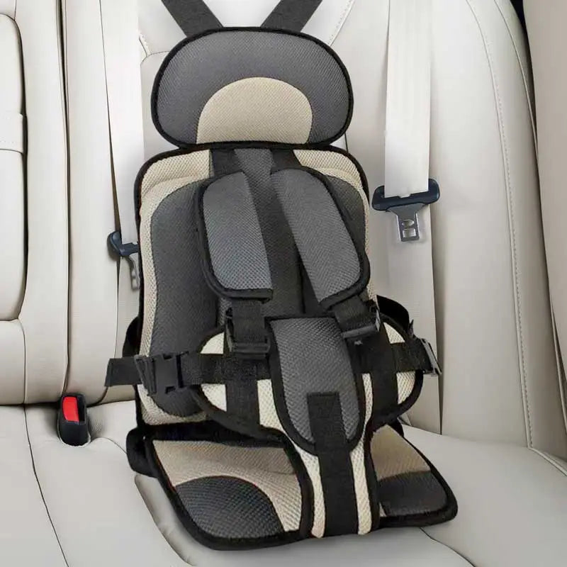 Child car cushion seat in red for ages 0-12, showcasing soft, compact design and secure restraints for safe, comfortable trav