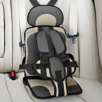 Child car cushion seat in red for ages 0-12, showcasing soft, compact design and secure restraints for safe, comfortable trav