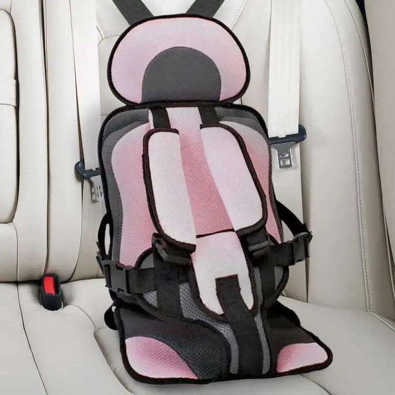 Child car cushion seat in red for ages 0-12, showcasing soft, compact design and secure restraints for safe, comfortable trav