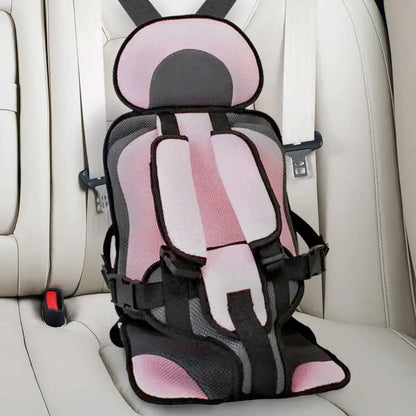 Child car cushion seat in red for ages 0-12, showcasing soft, compact design and secure restraints for safe, comfortable trav