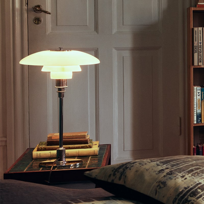 Contemporary Danish designer table lamp with warm LED light, sleek Scandinavian form, amber finish, and premium glass.