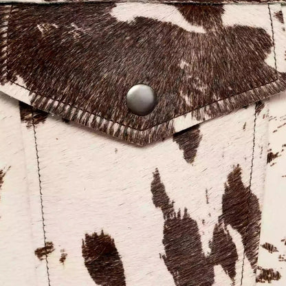 Cow print structured jacket, front view, single-breasted design, black and white pattern, women's fashion statement piece.