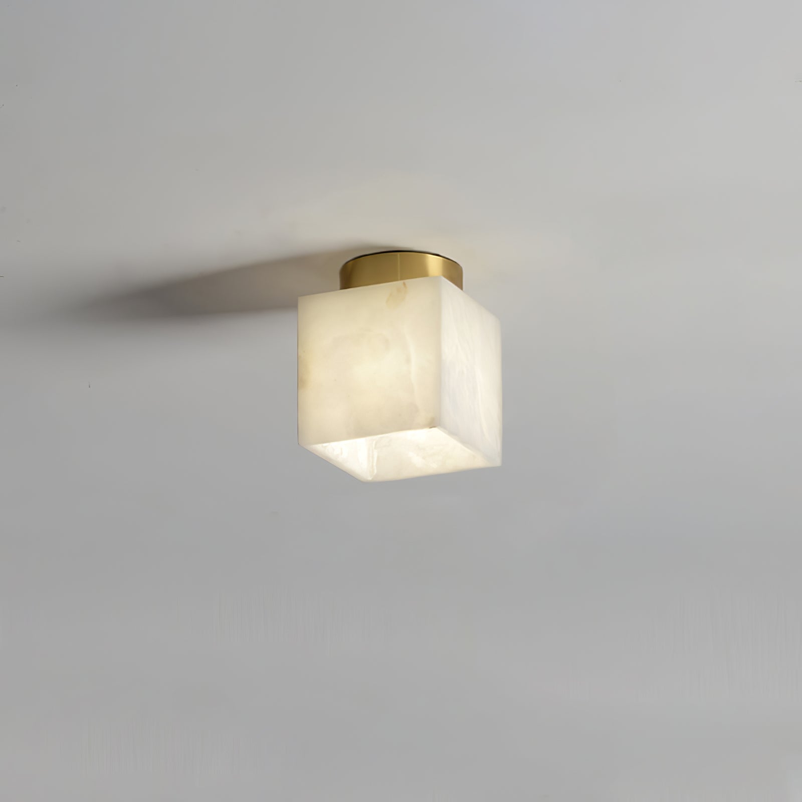 Elegant alabaster brass ceiling lamp, warm ambient light, celestial glow, sophisticated brass detailing, modern design.
