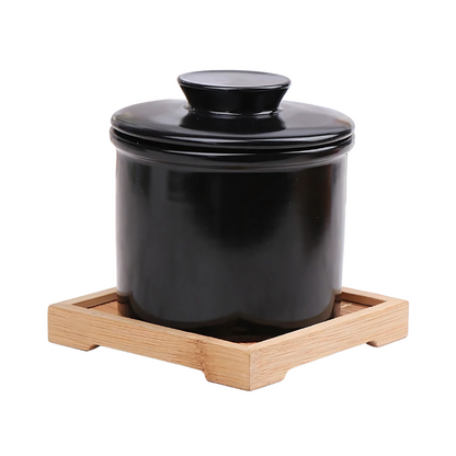 "Elegant ceramic butter keeper with water-sealed system in sleek black, light blue, and white, perfect for kitchen décor."