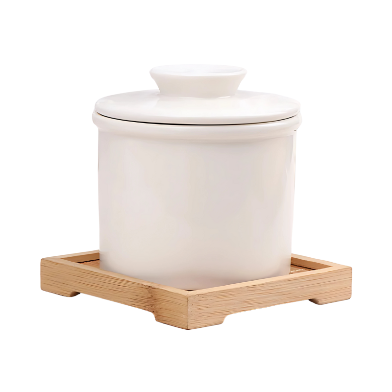 "Elegant ceramic butter keeper with water-sealed system in sleek black, light blue, and white, perfect for kitchen décor."