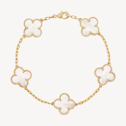 Elegant clover charm bracelet with polished black agate inlays and a gold and silver-tone chain for sophisticated style.