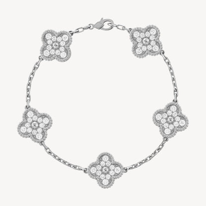 Elegant clover charm bracelet with polished black agate inlays and a gold and silver-tone chain for sophisticated style.