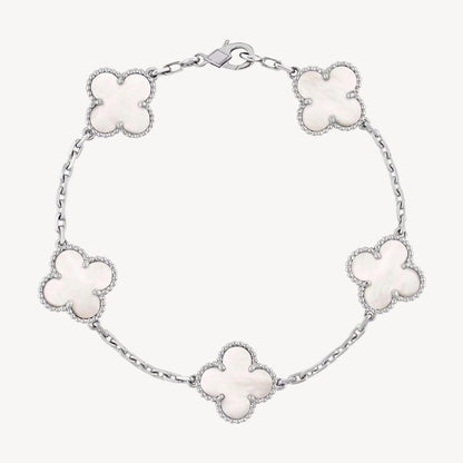 Elegant clover charm bracelet with polished black agate inlays and a gold and silver-tone chain for sophisticated style.