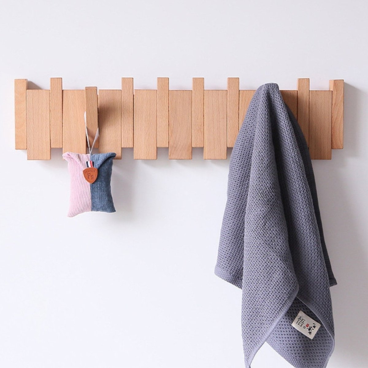 "Elegant handmade wooden piano coatrack front view, showcasing unique piano key design and quality craftsmanship in home deco