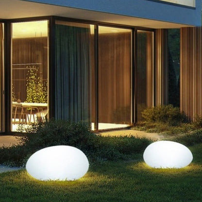 Elegant LED garden light with cobblestone design, glowing in multiple colors, ideal for illuminating outdoor spaces like gard