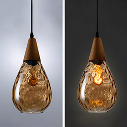 "Elegant teardrop glass pendant light with wood accents, available in clear, golden, smoky gray, perfect for any home decor."