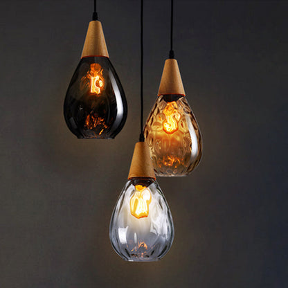 "Elegant teardrop glass pendant light with wood accents, available in clear, golden, smoky gray, perfect for any home decor."