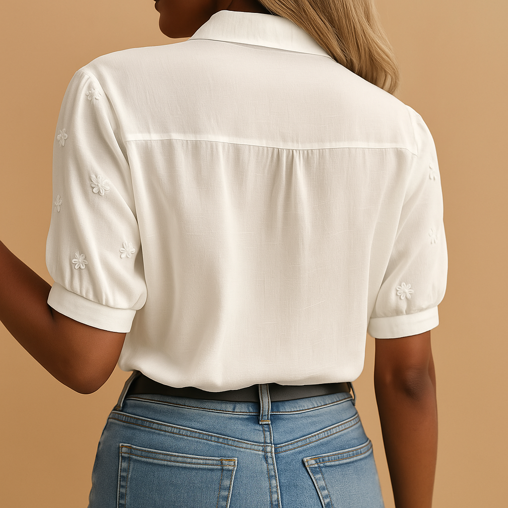 Elegant white blouse for women with classic collar and button closure, perfect for workwear or casual occasions.