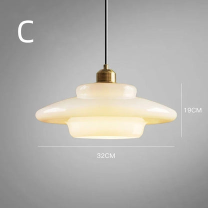Elegant white glass pendant light with brass fixture, mid-century design, perfect for modern or classic interiors, adds luxur