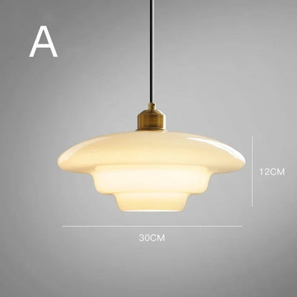 Elegant white glass pendant light with brass fixture, mid-century design, perfect for modern or classic interiors, adds luxur