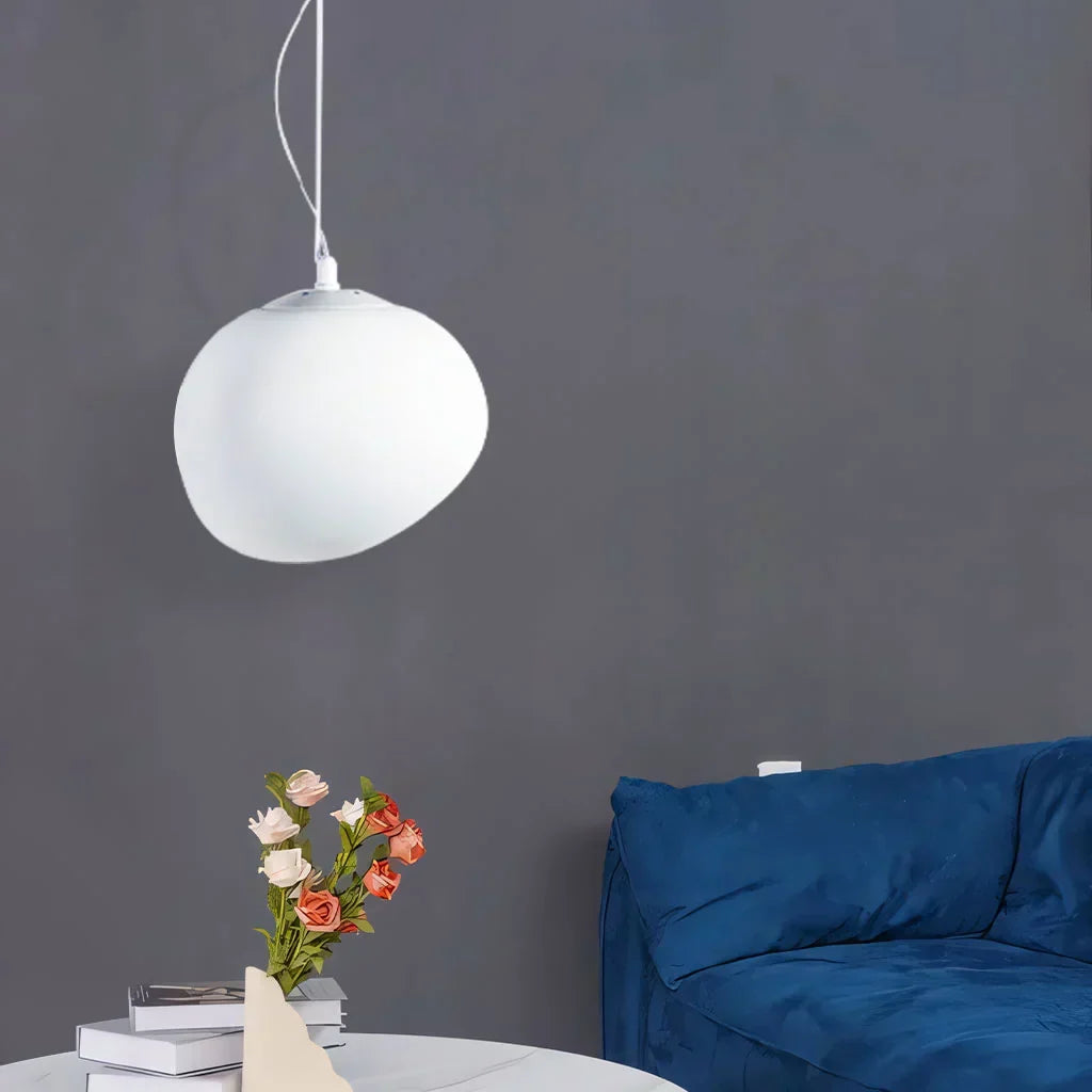Elegant white pebble pendant light; minimal design, frosted glass, metal accents, soft glow for modern interiors.