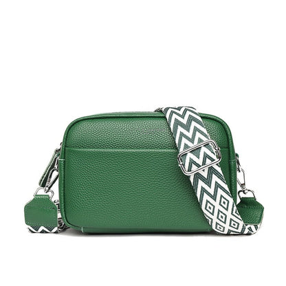 Elegant women's leather crossbody bag with adjustable strap, pebbled texture, ideal for casual or formal occasions.