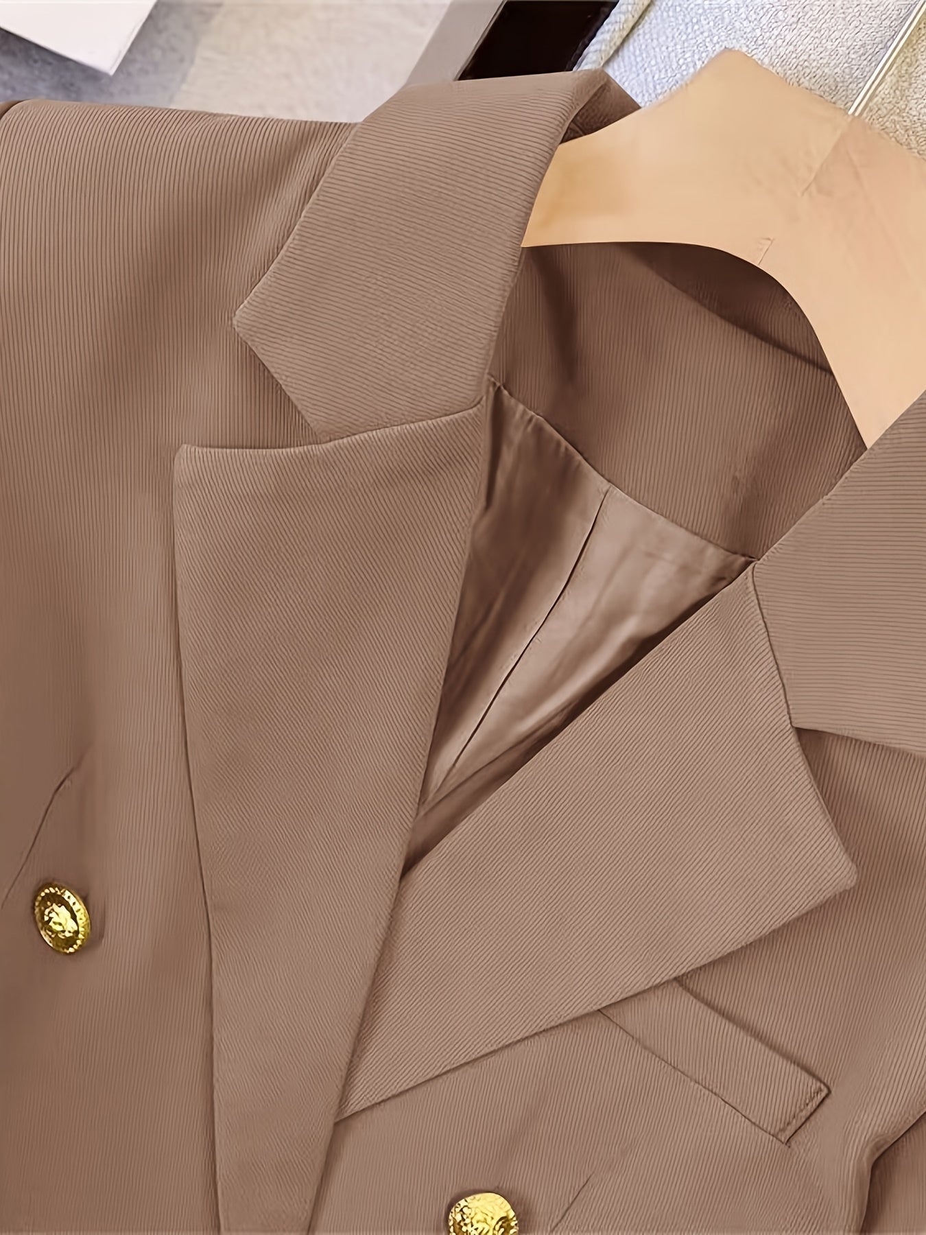 Elegant women's slim blazer with golden buttons, hip-length, long sleeves, in apricot, black, or camel, enhances style.