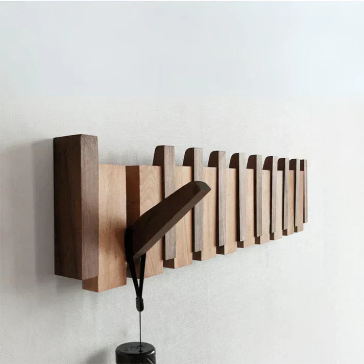 "Elegant wooden coat rack with piano key design, featuring multiple hooks for organizing coats and accessories."
