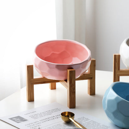 "Ergonomic elevated pet bowl with non-slip wooden stand, sleek design, blue color, enhances pet comfort and posture."