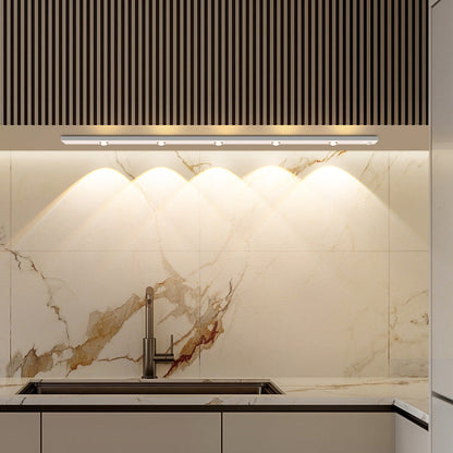 "LED motion sensor under cabinet light with cat-eye bulb, adjustable luminance, and magnetic installation in kitchen setting.