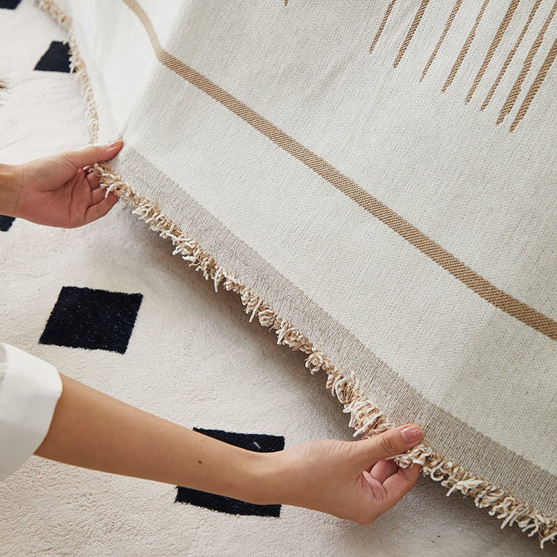 Luxurious sofa throw cover for sectionals, elegantly draped in soft, stretchable fabric, ideal for modern home decor.