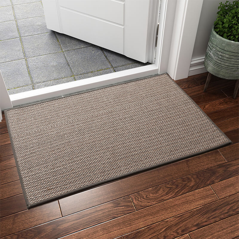 Machine washable woven indoor door mat with a timeless weave pattern, non-slip backing, and plush polypropylene surface.