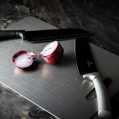 Medical grade titanium cutting board with non-porous silver surface, rounded edges, and ergonomic design for ultimate hygiene