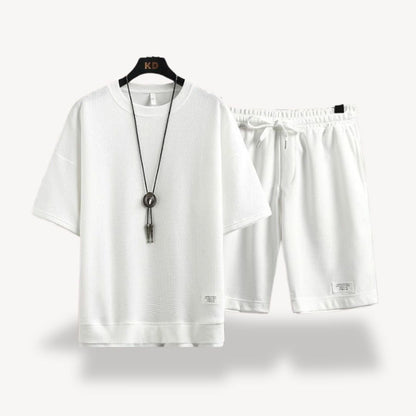 "Men wearing dark gray cotton jersey shorts set, showcasing relaxed fit and minimalist design for casual comfort"