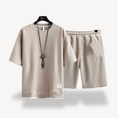 "Men wearing dark gray cotton jersey shorts set, showcasing relaxed fit and minimalist design for casual comfort"