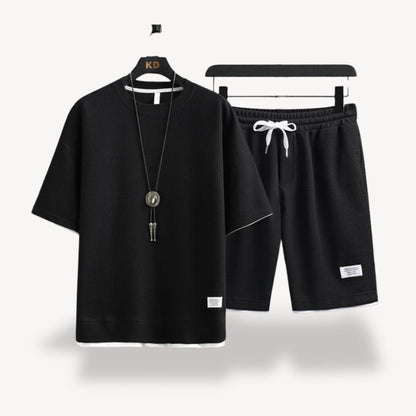 "Men wearing dark gray cotton jersey shorts set, showcasing relaxed fit and minimalist design for casual comfort"