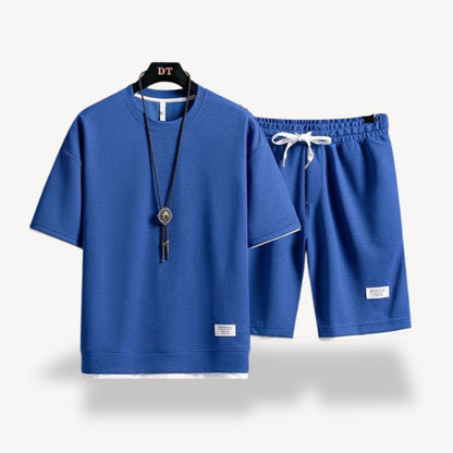 "Men wearing dark gray cotton jersey shorts set, showcasing relaxed fit and minimalist design for casual comfort"