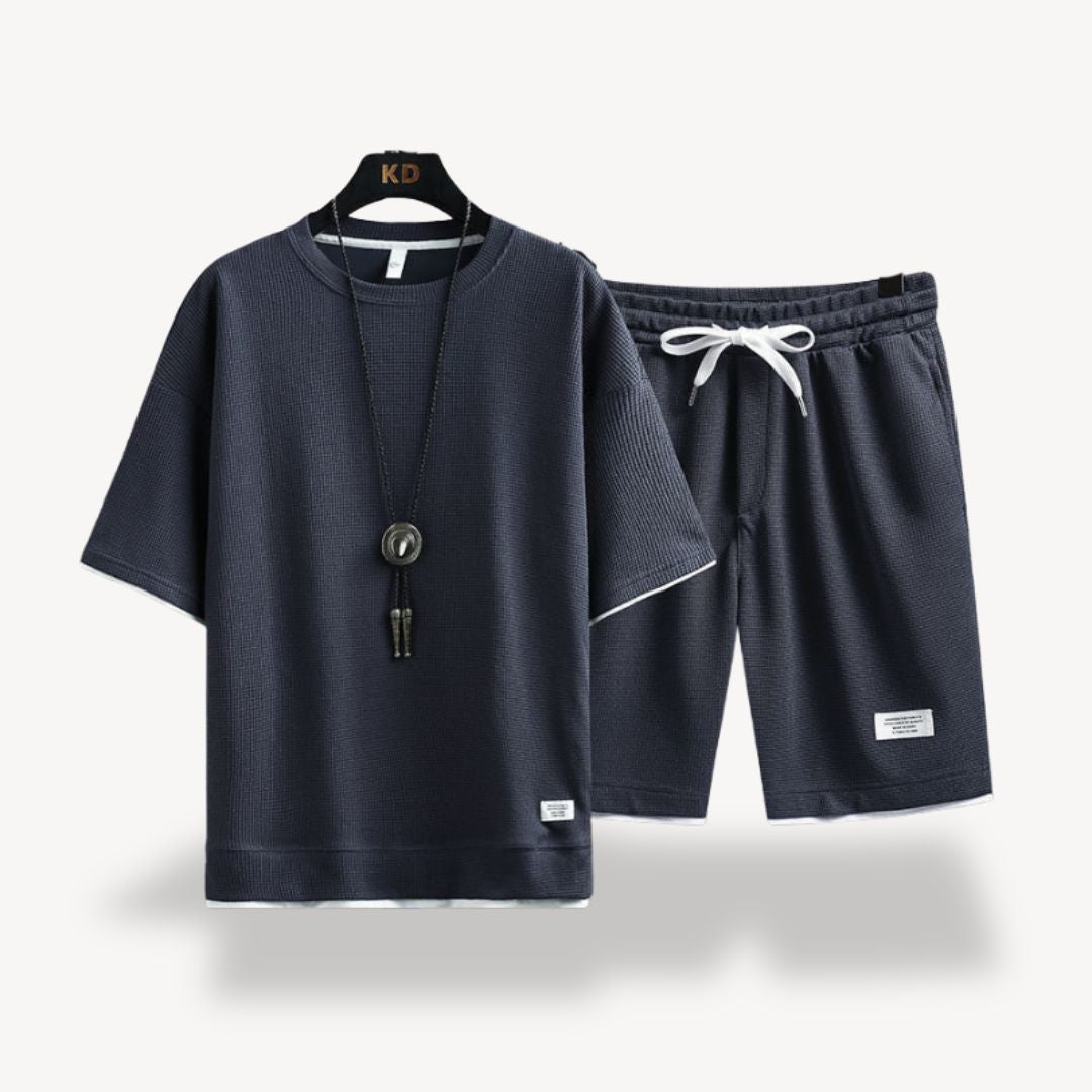 "Men wearing dark gray cotton jersey shorts set, showcasing relaxed fit and minimalist design for casual comfort"