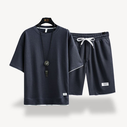 "Men wearing dark gray cotton jersey shorts set, showcasing relaxed fit and minimalist design for casual comfort"