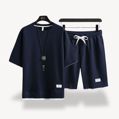"Men wearing dark gray cotton jersey shorts set, showcasing relaxed fit and minimalist design for casual comfort"