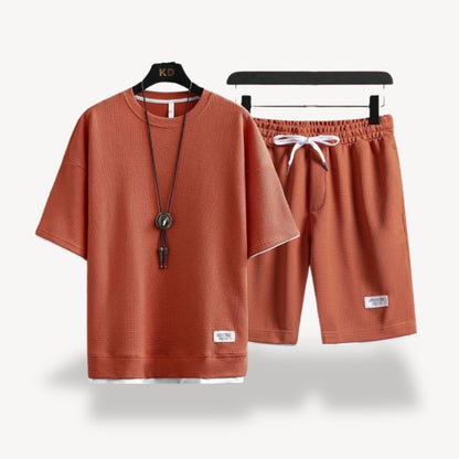 "Men wearing dark gray cotton jersey shorts set, showcasing relaxed fit and minimalist design for casual comfort"