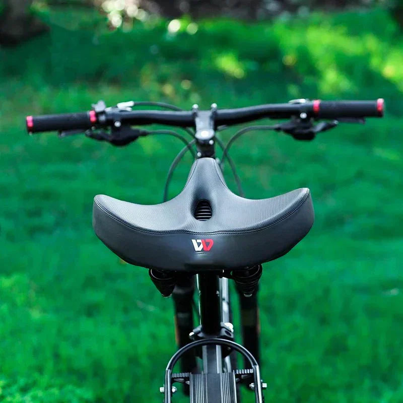 "Men's bike saddle with wide seat, ergonomic design, memory foam padding, black synthetic leather, and universal fit compatib