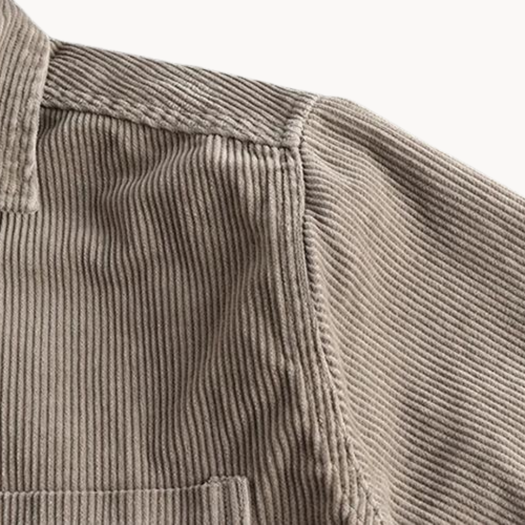 Men's classic orange corduroy shirt with button-down front and textured fabric, ideal for layering and timeless style.