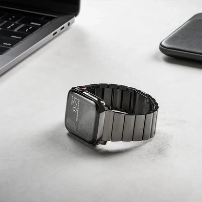 Men's sleek titanium watch band with shiny finish, magnetic clasp, durable and lightweight; perfect for daily or formal wear.