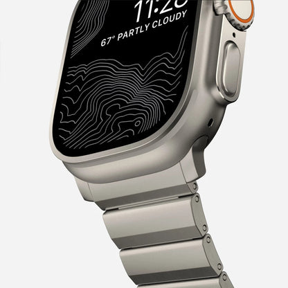 Men's sleek titanium watch band with shiny finish, magnetic clasp, durable and lightweight; perfect for daily or formal wear.