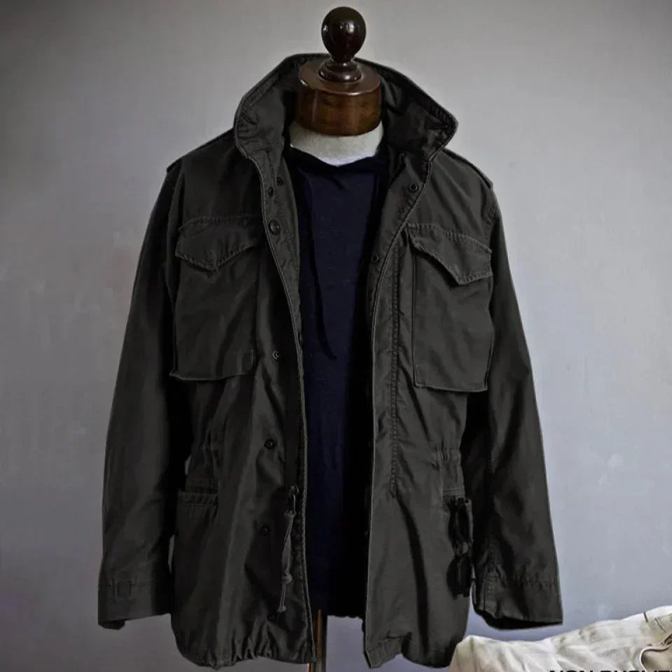 Men's vintage cotton field jacket with adjustable waist, rugged design, breathable fabric, suitable for layering.