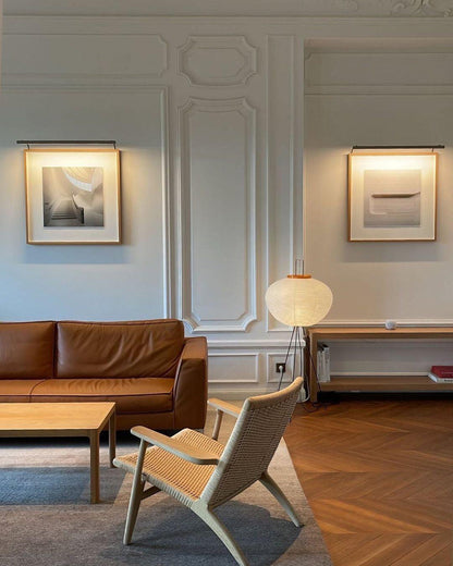 "Minimalist rice paper floor lamp with sleek metal frame and soft diffused light, perfect for creating a warm ambiance."