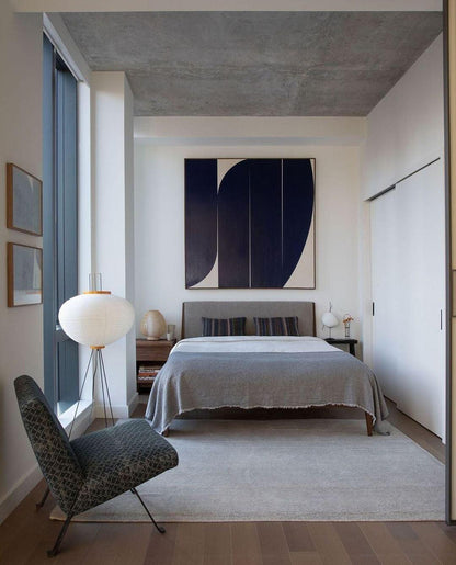 "Minimalist rice paper floor lamp with sleek metal frame and soft diffused light, perfect for creating a warm ambiance."