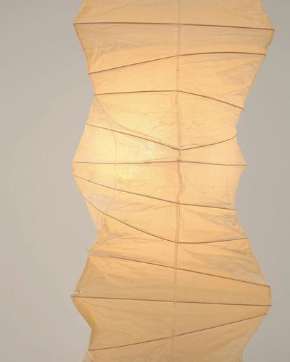 "Minimalist rice paper floor lamp with sleek metal frame and soft diffused light, perfect for creating a warm ambiance."