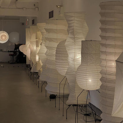 "Minimalist rice paper floor lamp with sleek metal frame and soft diffused light, perfect for creating a warm ambiance."